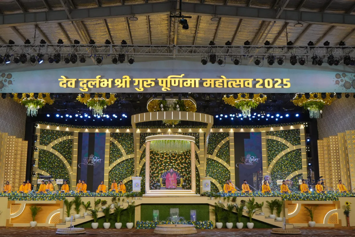 Walls of flowers and greenery around the stage of Shri Guru Purnima Mahotsav 2025 at Nurmahal Ashram